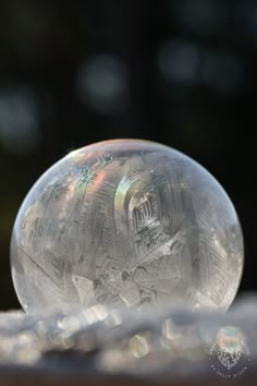 a clear bubble sitting on top of a wooden table