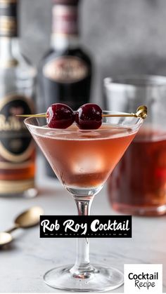 a martini with two cherries on the rim