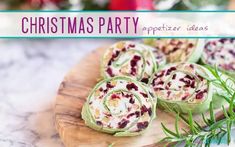 christmas party appetizers on a wooden platter with greenery in the background