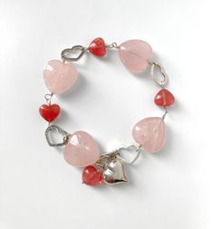 This one-of-a-kind handmade bracelet is made entirely from Sterling silver, rose quartz and cherry quartz beads. The bracelet can be adjusted up to 9 inches = 23cm long and is finished with a puffy silver heart charm. The last two photos show examples of how the bracelet can be worn. It is safely gift-wrapped in a presentation box or pouch. Hippie Bracelets, Gemstone Beaded Bracelets, Quartz Bracelet, Quartz Rose, Silver Heart, Beaded Chain, Pink Heart, Chain Link Bracelet, Semi Precious Gemstones