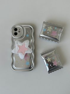 there is a cell phone case and two candy bars in the shape of a star