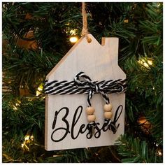 a wooden ornament hanging from a christmas tree with the word blessing written on it