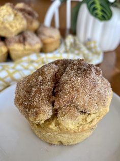 a close up of a plate of food with muffins in the back ground