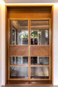 an open wooden door with glass panels