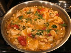 a pot filled with pasta and vegetables on top of a stove