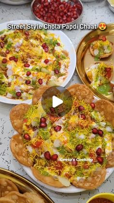 several plates filled with different types of food on top of a white table covered in condiments