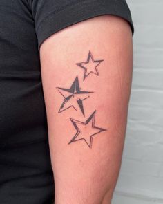 three stars tattoo on the left arm