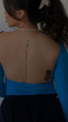 a woman with a tattoo on her back