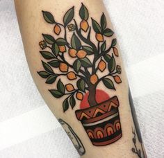 an orange tree in a pot with leaves on the side of his leg tattoo design