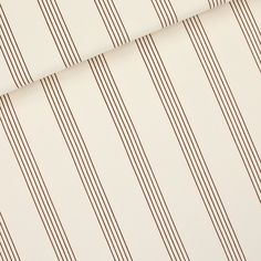 a white and brown striped wallpaper with vertical lines