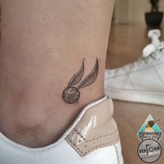 a close up of a person's foot with a tattoo on it