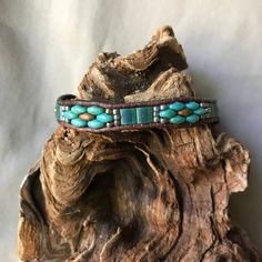 Unique, Southwestern inspired, handmade leather and beaded bracelet. This bracelet, is a single strand using Opaque Yellow Copper Picasso and deep turquoise tone Picasso SuperDuo glass beads, as well Matte Transparent Green Tila beads. They have been accented by Gilded Marble Turquoise colored seed Rustic Adjustable Turquoise Beaded Bracelets, Adjustable Beaded Turquoise Leather Bracelet, Adjustable Turquoise Beaded Leather Bracelet, Bohemian Leather Beaded Bracelet For Healing, Southwestern Hand Wrapped Beaded Bracelets, Adjustable Turquoise Western Bracelet, Rustic Handmade Turquoise Beaded Bracelets, Bohemian Turquoise Leather Bracelet With Round Beads, Southwestern Style Turquoise Leather Bracelet For Festivals