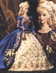 a barbie doll wearing a blue and white dress with gold trimmings on it