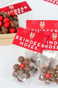 chocolate candies wrapped in red and white paper with reindeer stickers on them next to boxes of candy