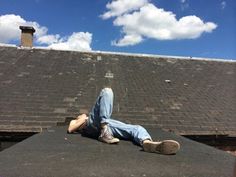 a man laying on the ground next to a skateboard