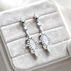 Our amazing white opal crystal earrings are a perfect choice for a bride looking for a modern vintage style.  So much detail in these beauties !   - Handcrafted with genuine Austrian Crystals - Each stone is set by hand in my studio - White opal crystals - Antique silver finish - Earrings measure 2-1/8 inches - Handcrafted in the US. - Nickel free and hypoallergenic - PLEASE ALLOW APPROX 10 DAYS FOR COMPLETION BEFORE SHIPPING This is an original design by © Treasures by Agnes Browse our earrings: https://www.etsy.com/shop/treasures570?ref=seller-platform-mcnav§ion_id=6861728 Browse our backdrop necklaces: https://www.etsy.com/shop/treasures570?ref=seller-platform-mcnav§ion_id=11378666 Browse our necklaces: https://www.etsy.com/shop/treasures570?ref=seller-platform-mcnav§ion_id=6800043 Brow Bridal Jewellery Inspiration, Rose Gold Wedding Jewelry, Modern Vintage Style, Backdrops Necklace, Modern Vintage Fashion, Jewelry Antique, Bridal Bracelet, Perfect Palette, Wedding Jewelry Earrings