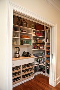 an open pantry with lots of items on the shelves and in front of it is a phone