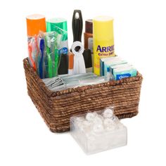 a brown basket filled with lots of different types of toothbrushes and hygiene products