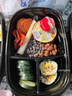 two plastic containers filled with food on top of a counter