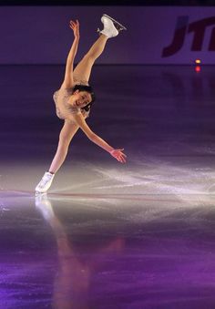 a female figure skating on an ice rink