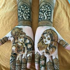 two hands with henna designs on them