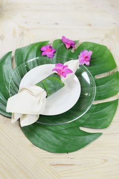 there is a plate with pink flowers on it and two napkins in the middle