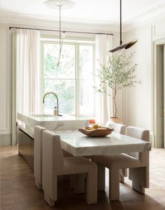 a kitchen with a table and chairs in it