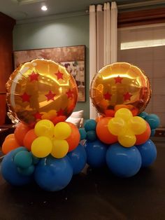 two balloons with stars on them sitting on a table