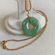 Up for sale is this vintage estate 14 karat solid yellow gold 17.5" rope chain necklace with 14 karat solid yellow gold Chinese jade disc pendant.  The chain measures approximately 2mm wide and 17.5" end to end.  The Chinese jade disc pendant measures approximately 1-1/16" in diameter and features decorative 14 karat solid gold Chinese accents.  The chain weighs 4.0 grams.  The pendant weighs 5.3 grams.  The spring ring clasp and end tag on the chain are stamped 585.  The bail on the pendant is Jade Necklace Pendant Chinese, Antique Gold Plated Round Necklace, Antique Gold-plated Round Necklace, Vintage Tarnish Resistant Necklace, Classic Round Rope Chain Necklaces, Vintage Yellow Gold Rope Chain Necklace, Vintage 14k Stamped Necklace, Vintage Hallmarked Round Chain Necklace, Vintage Rope Chain Necklace As Gift