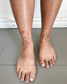 a woman's bare feet with tattoos on them