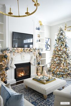 a living room filled with furniture and a christmas tree in front of a fire place