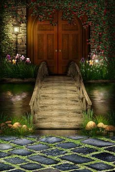 a wooden bridge leading to a door with flowers growing on the wall and grass around it