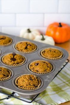 a muffin tin filled with cupcakes on top of a table