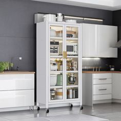 a kitchen with white cabinets and black walls