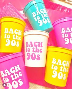 colorful plastic cups with the words back to the 90's written in white on them