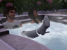 two people sitting in a hot tub with flowers on the side and one person standing up