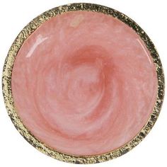 a pink and gold plate on a white background