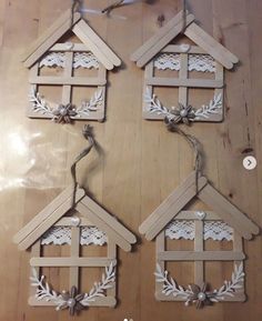 four wooden house ornaments hanging on a wall