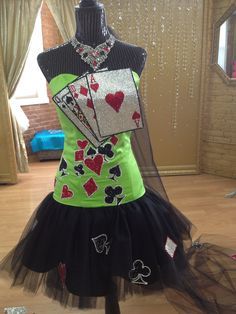 a dress made to look like a queen of hearts and playing cards is displayed on a mannequin