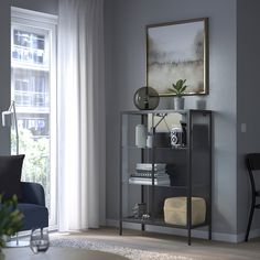 a living room with grey walls and furniture