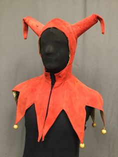 a mannequin's head wearing an orange costume