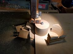 a piece of wood is being cut with a circular sawtoothing machine on top of it