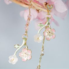 A pair of elegant sakura Japanese cherry blossom asymmetric dangle drop earrings features a heart stud and a long tassel cherry blossom enamel charm, asymmetric design which give the pair a unique look. Materials: Alloy metal, resin beads, rhinestones, enamel Shipping Policy: Orders will be shipped within 1-3 business days. Economy shipping will take 7-14 days to arrive and standard shipping is 1- 4 days for U.S. orders. International shipping time is depended per country and per shipping method Japanese Cherry Blossom Branch, Cherry Blossom Jewelry, Sakura Japanese, Feminine Face, Cherry Blossom Flower, Blossom Branch, Cherry Blossom Branch, Eye Makeup Designs, Cherry Blossom Flowers