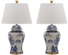 two blue and white vases with lamps on top of eachother, one holding a lamp