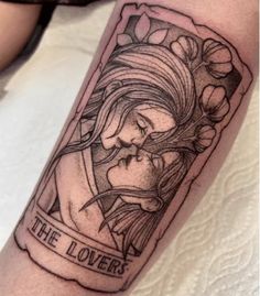 a tattoo on the arm of a woman with an image of a mother and child