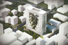 an aerial view of a building surrounded by tall white buildings and lots of greenery