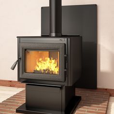 a black stove sitting on top of a brick floor