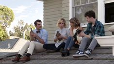 a group of people sitting on the roof of a house