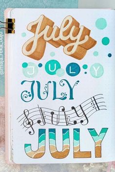 an open notebook with the words july written in cursive and music notes on it