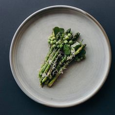 asparagus on a plate with sprouts and parmesan cheese